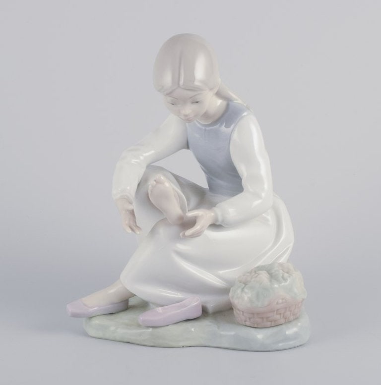 NAO, Spain. Porcelain figurine of a girl having a rest. Circa 1980s. - 2