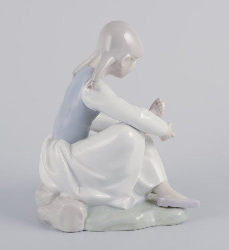 NAO, Spain. Porcelain figurine of a girl having a rest. Circa 1980s. - 4
