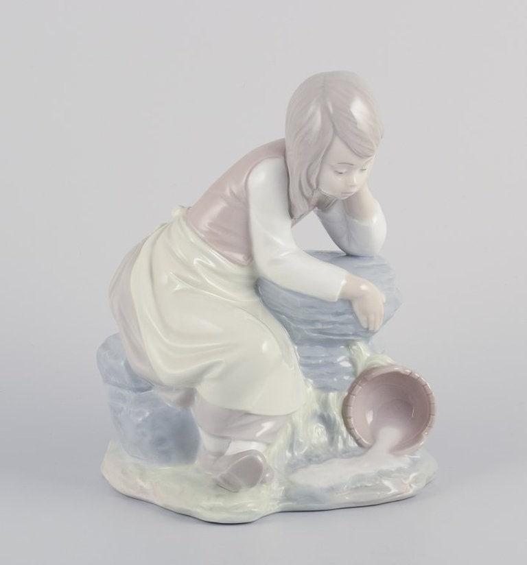 NAO, Spain. Porcelain figurine of a girl taking a rest. Circa 1980s. (1 of 8)