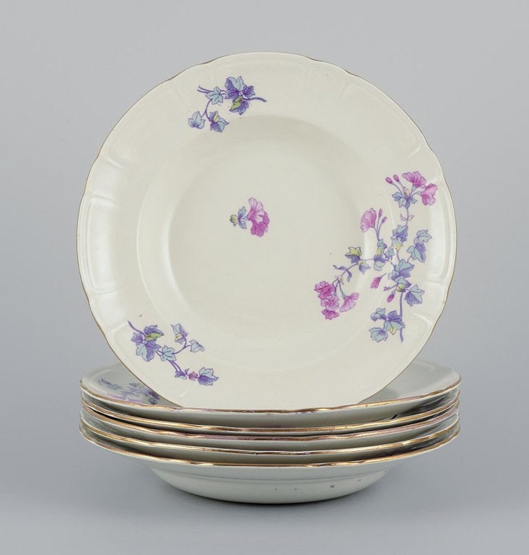 Gustafsberg, Sweden. A set of six deep 'Geranium' earthenware plates. 1918. - 2