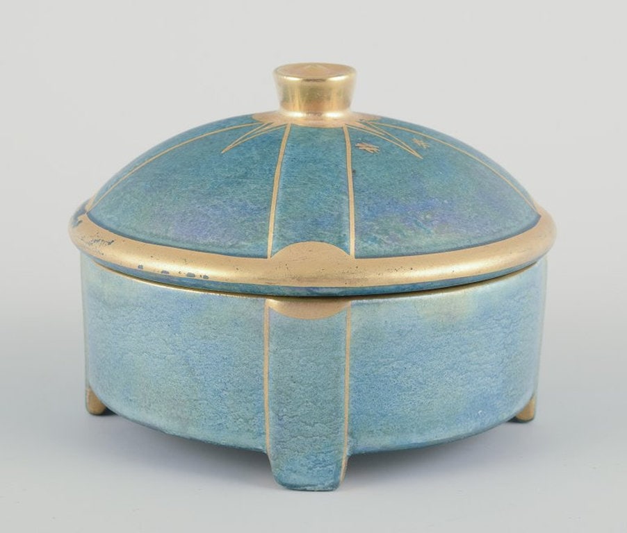 Josef Ekberg for Gustavsberg, Sweden. Bonbonniere in porcelain. 1940s.: Josef Ekberg for Gustavsberg. Bonbonniere in porcelain. Hand-painted in lustre glaze, gold decoration. Green-blue tones. Art Deco. Dating: 1940s. Perfect unused condition. Marked. Dimensions: D 9.0 cm