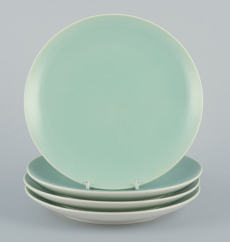 Alumina, Denmark. Four 'Confetti' plates in mint green glazed earthenware. Mid 20th century.: Four Aluminia "Confetti" plates in mint green glazed earthenware. Mid 20th century. In excellent condition, with natural crazing. Marked. First factory quality. Diameter: 19,8 cm.; Four Aluminia "Conf