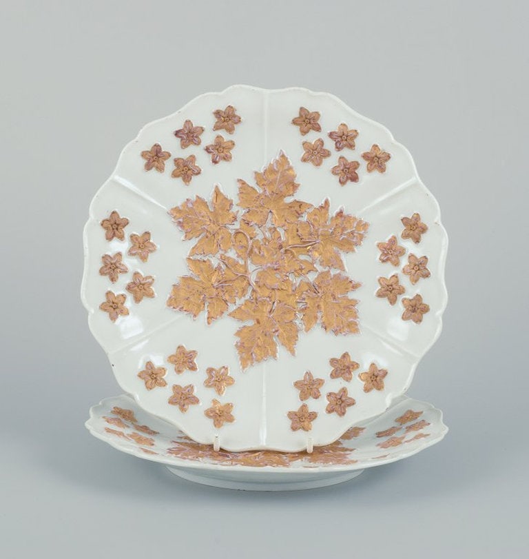 Meissen, Germany. A pair of antique porcelain plates decorated with flowers in gold leaf. Late 19th: Meissen, Germany. A pair of antique porcelain plates decorated with flowers in gold leaf. Late 19th century. Marked. First factory quality. In good condition, with signs of use and two minimal chips o