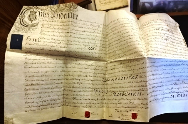 1761 English Vellum Indenture Red Wax Seals.: Large handwritten English Vellum indenture dated 1761 during the reign of George the Third, being the conveyance of property in Somerset by a Malster and a Yeoman to a Yeoman. Fancy printed vignette