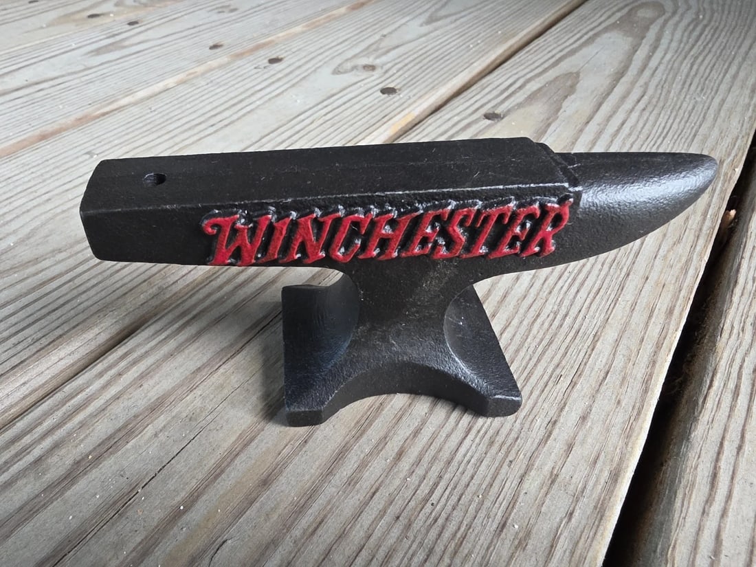 Cast Iron Winchester Miniature Anvil: 5 1/2" long x 2 1/2" Tall x 1 3/4" Wide A wonderful reproduction cast iron collectible advertising Winchester anvil. Advertising pieces like this many times were given to shops or used as sales