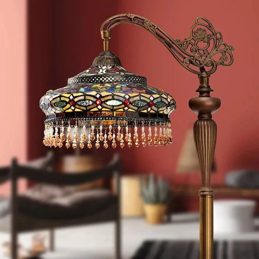French Stained Glass Reading Floor Lamp: This Tiffany-style floor lamp carries a distinctly European elegance, recalling the romantic glow of late-19th-century Parisian interiors. The mosaic glass shade, composed of softly muted jewel tones,