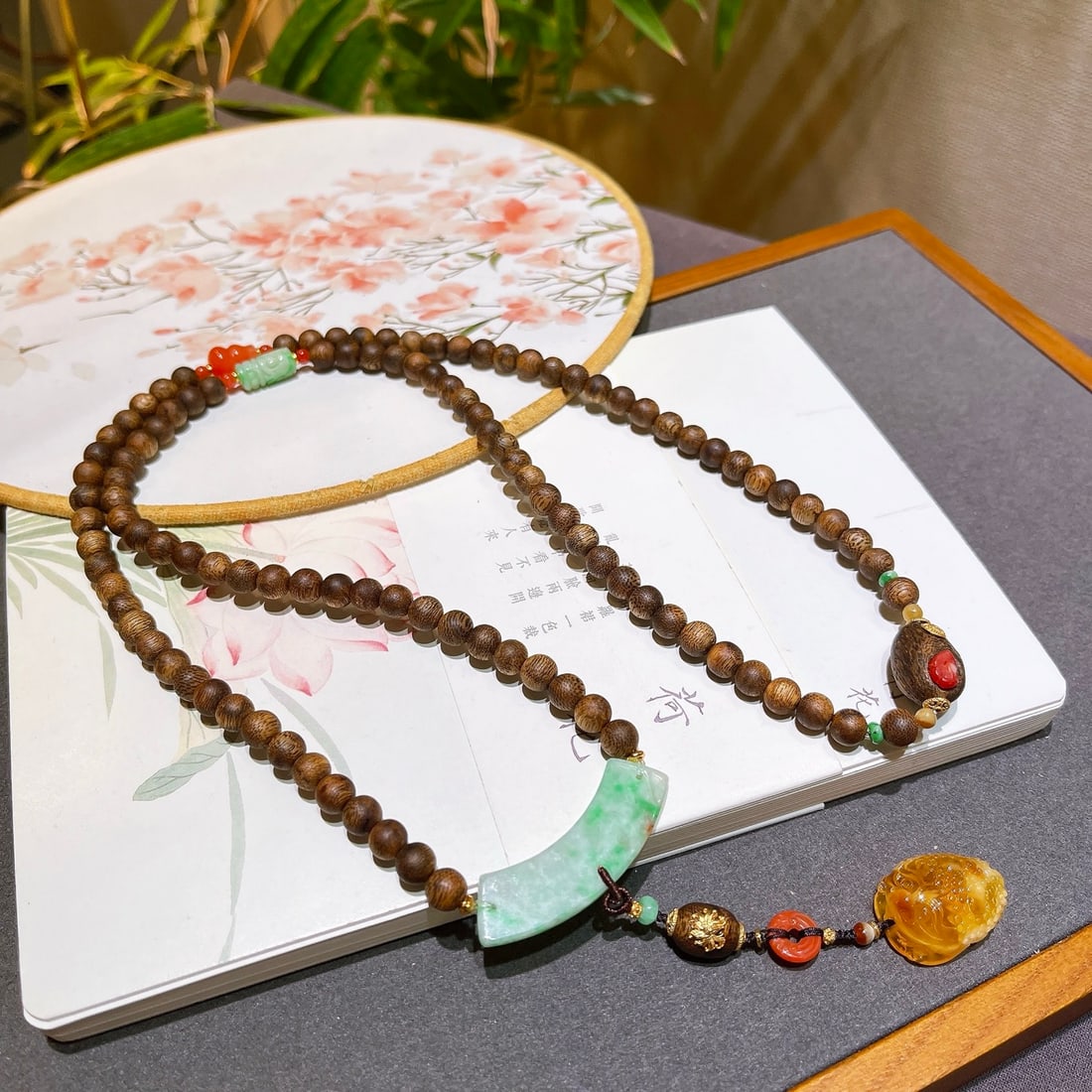 Natural Jadeite & Chenxiang Wood Necklace: Title: Natural Jadeite & Chenxiang Wood Necklace Origin: Chinese Date/Period: After2000 Materials: Jadeite & Chenxiang Wood Dimensions: 6.6(mm) 0.26(inches) Reserve: $279.00 Shipping: Domestic: