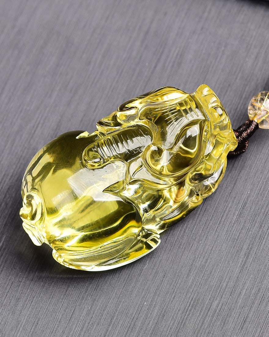 Yellow Crystal Hand Carved Pixiu Pendant: Title: Yellow Crystal Hand Carved Pixiu Pendant Origin: Chinese Date/Period: After2026 Materials: Crystal Dimensions: 49x27x21(mm) 1.93x1.06x0.83(inches) Weight 0.09 lbs/41g Reserve: $189.00