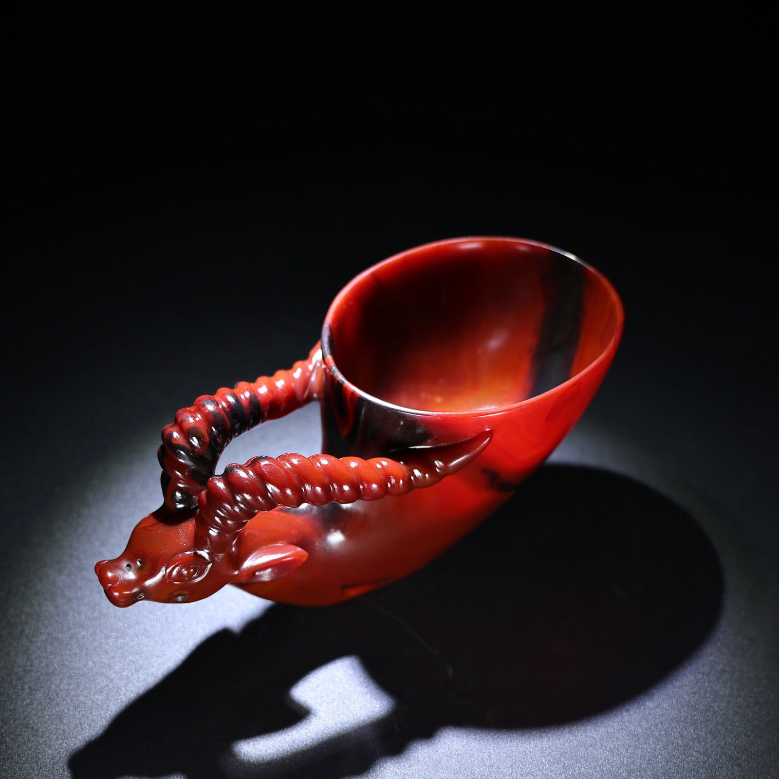 Red Agate Hand-Carved Cup w Fortune Ox: Title: Red Agate Hand-Carved Cup w Fortune Ox Origin: Chinese Date/Period: After1900 Materials: Agate Dimensions: 215 x 108 x 99 (mm) 8.46 x 4.25 x 3.90 (inches) Weight: 2.33 lbs/ 1056 g Reserve: