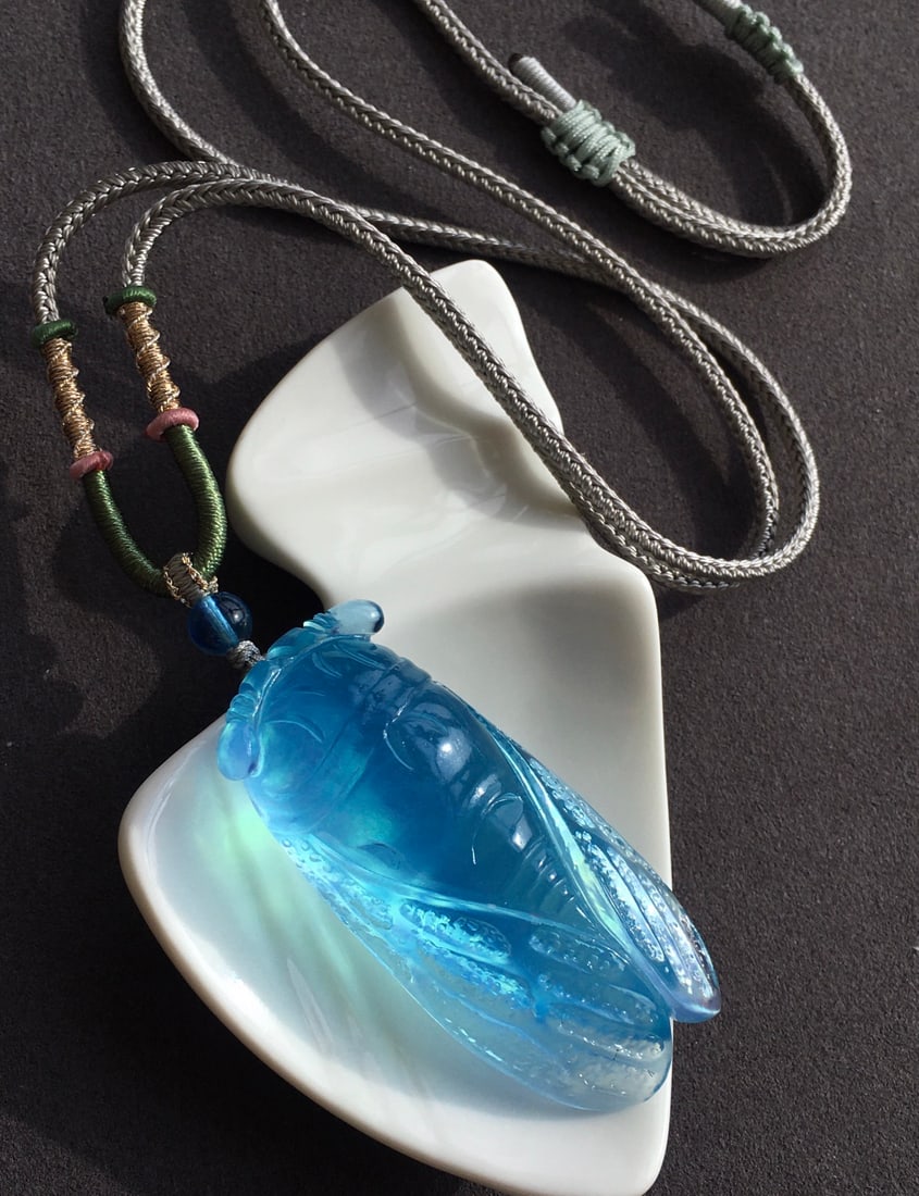 Aquamarine Hand-Carved Pendant w Fortune Cicada & w Hand Woven Necklace: Title: Aquamarine Hand-Carved Pendant w Fortune Cicada & w Hand Woven Necklace Origin: Chinese Date/Period: After2026 Materials: Aquamarine Dimensions: 53 x 24 x 17.5 (mm) 2.09 x 0.94 x 0.69