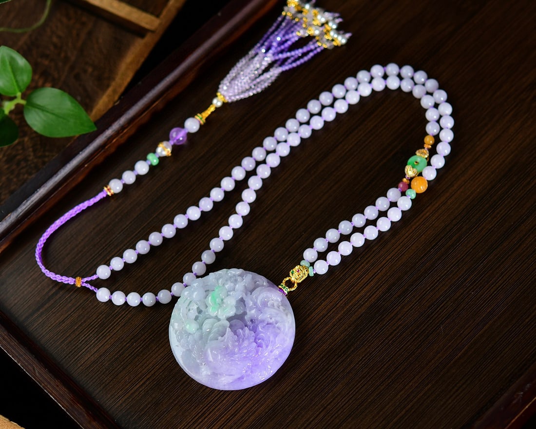 Purple Jadeite Hand-Carved Pendant w Phoenix & Peony & Hand Woven Beads Necklace: Title: Purple Jadeite Hand-Carved Pendant w Phoenix & Peony & Hand Woven Beads Necklace Origin: Chinese Date/Period: After2026 Materials: Jadeite Dimensions: 51.7 x 11.8 (mm) 2.03 x 0.46 (inches)