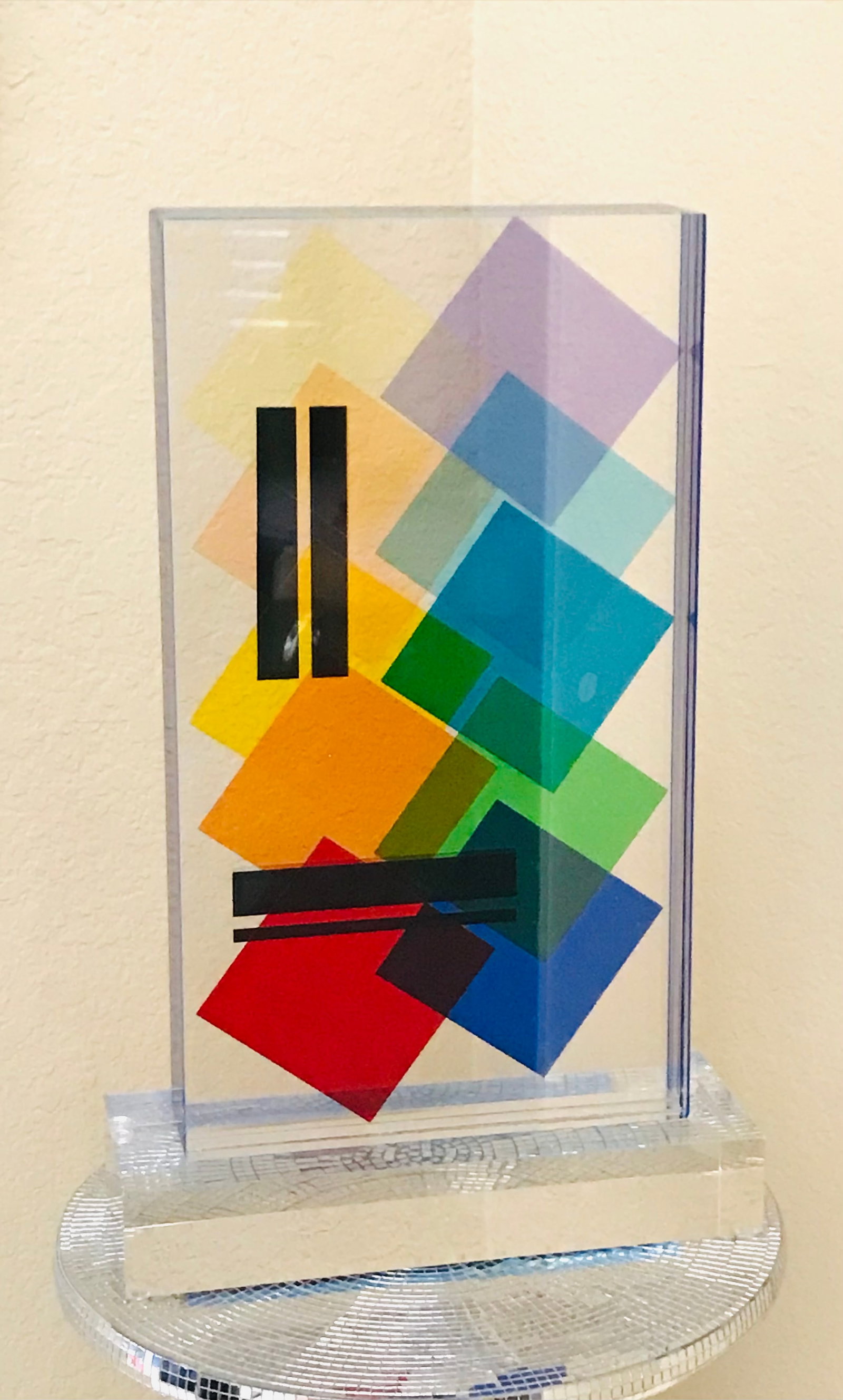 Lucite Acrylic sculpture Topazio by Grace Absi: A sculpture of a Lucite block handcrafted in the interiors with a geometric motif, laminated together on a clear, thick base, and hand-signed by the artist Grace Absi. It is in fine condition and