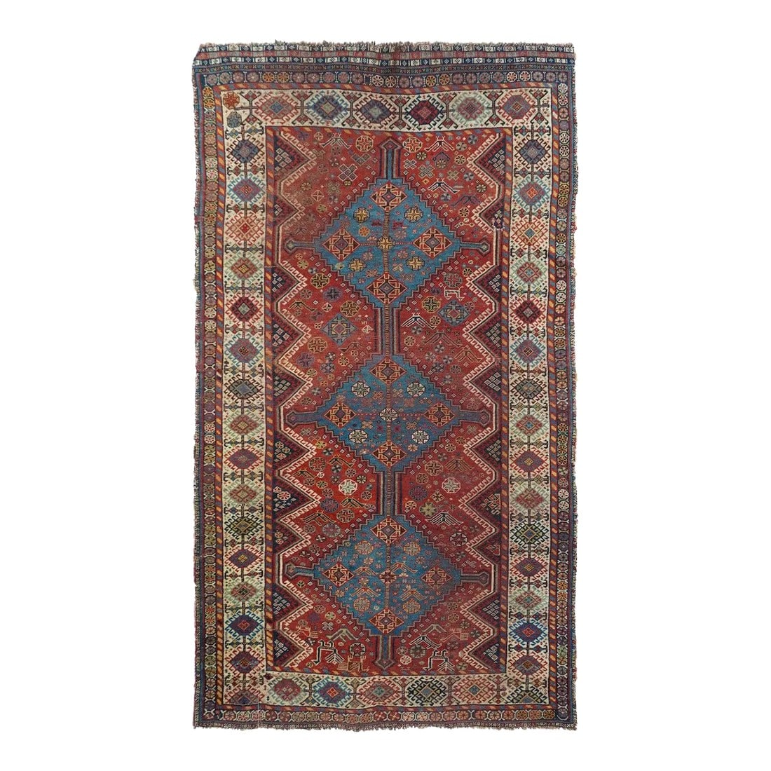 Antique Qashqai Rug 4'5'' x 7'7'': A bold light blue three stepped diamond pole medallion runs nearly the full n of the red field, and both are en suite decorated with star-octagons and cross-centred diamonds. Lateral dark blue