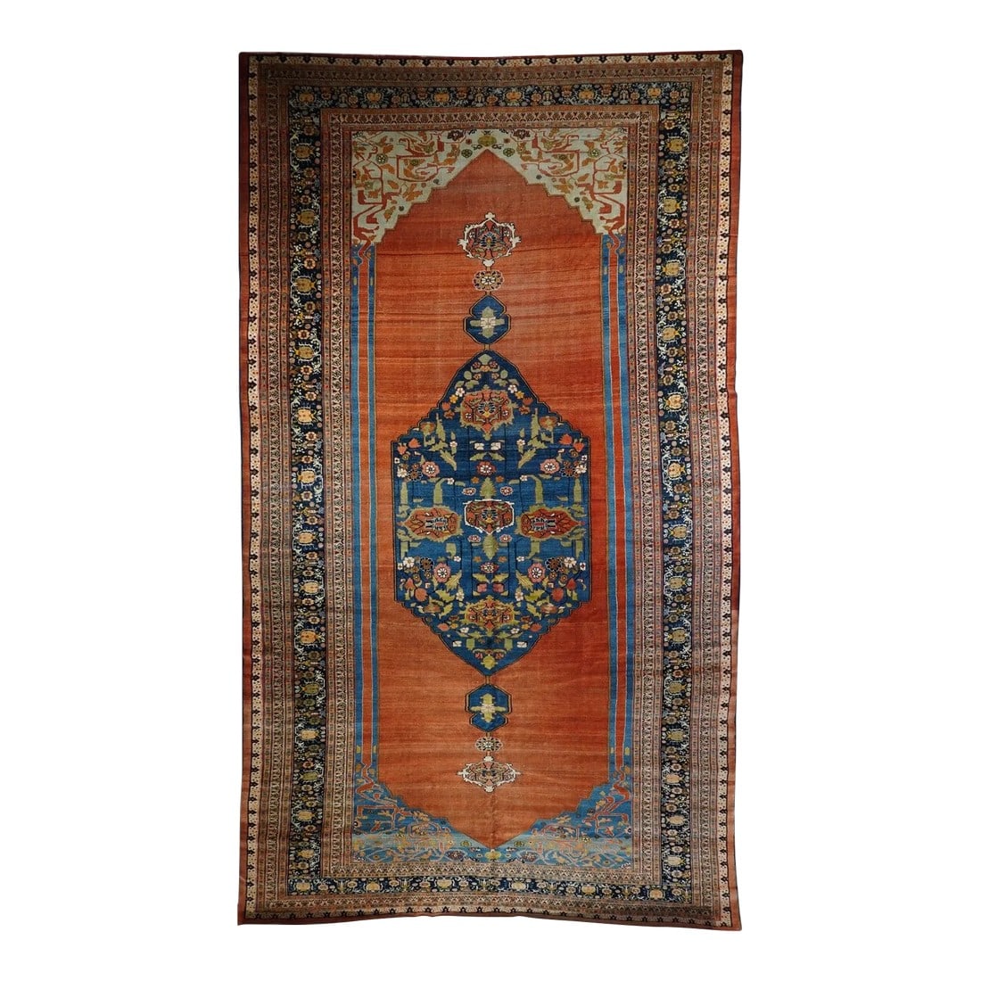 Late 18th Century Antique Haji Jalili Rug 9'7'' x 17'7'': The hexagonal royal blue pendanted medallion encloses red palmettes cartouches, green barbed leaves and little ecru rosettes, all on the attractively abrashed rust-red open subfield. Light/medium blue
