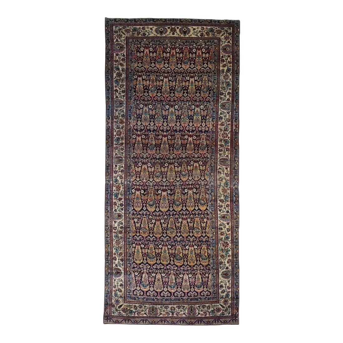 Antique Lavar Kerman Rug 6'2'' X 14'6'': Nine offset rows of cypress trees are separated by leaves and flowers on the deep navy indigo ground of this. Paired botehs alternate with petaled fan flowers on the yellow-green cypresses. Ecru