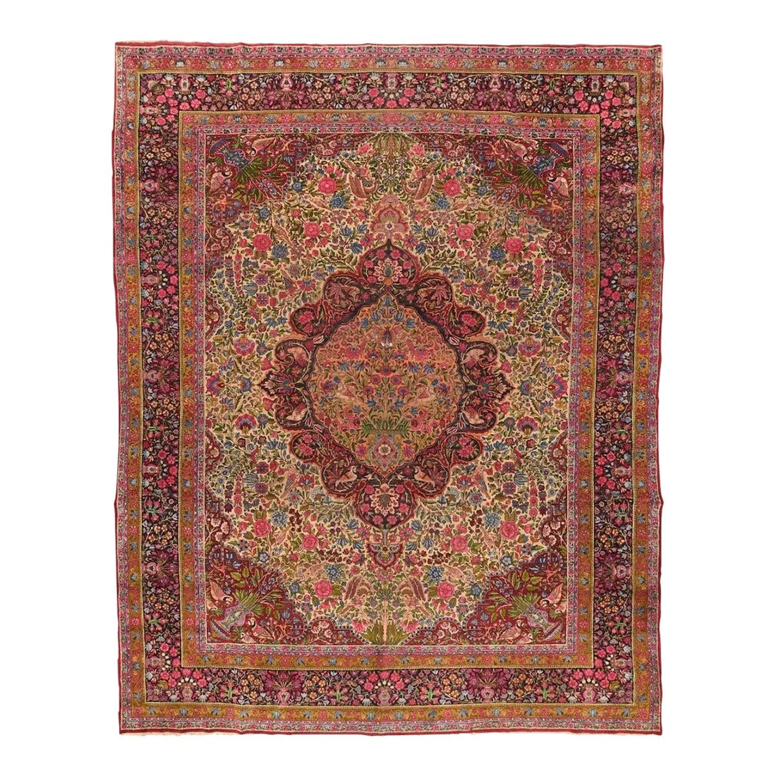 Antique Kerman Rug 10'0'' x 13'4'': Birds perch in the cusped navy medallion and in the straw-gold sub-medallion with a vase and "tree of life" design. More birds appear in the ecru ivory field among the dense foliate. Still more birds