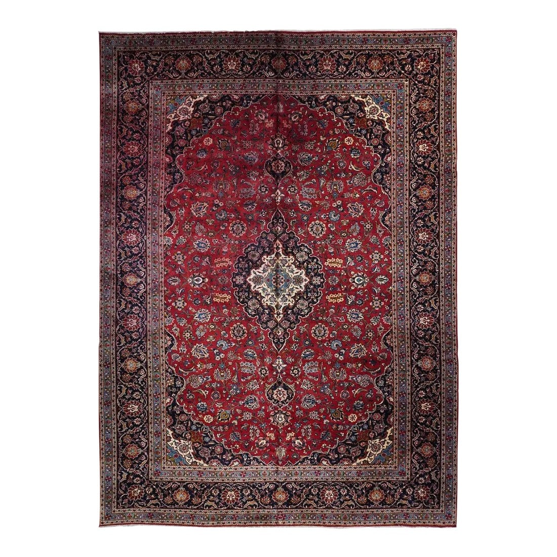 1960s Vintage Kashan Rug 10'8'' x 14'3'': This is everything a classic urban Kashan carpet should be: ruby red field with a bilateral arrangement of palmettes, carnations and vines; navy and cream nested flame edged, ogival pendanted
