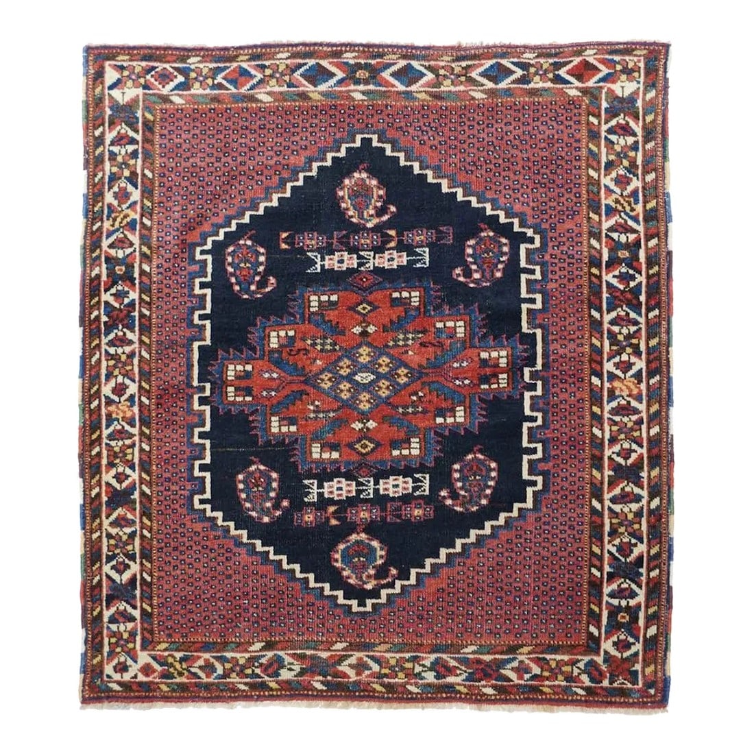 Antique Afshar Rug 3'6'' x 3'10'': This squarish, small SE Persian tribal weaving features a coral red field decorated by tiny blue dots, and centred by a navy stepped and notched hexagon enclosing floriated botehs and a characteristic