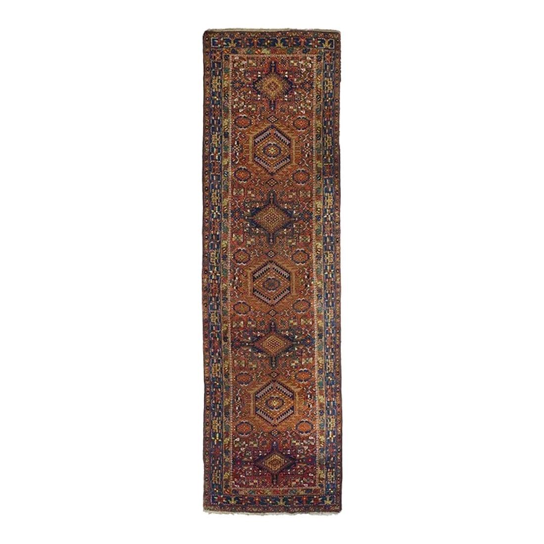 Vintage Karajeh Runner 3'4'' X 11'4'': The warm tomato field shows a run of seven disjoint characteristic medallions alternating in octogramme and hooked hexagon designs. Secondary rosettes mirror ones in main hexagons. Royal blue main bor