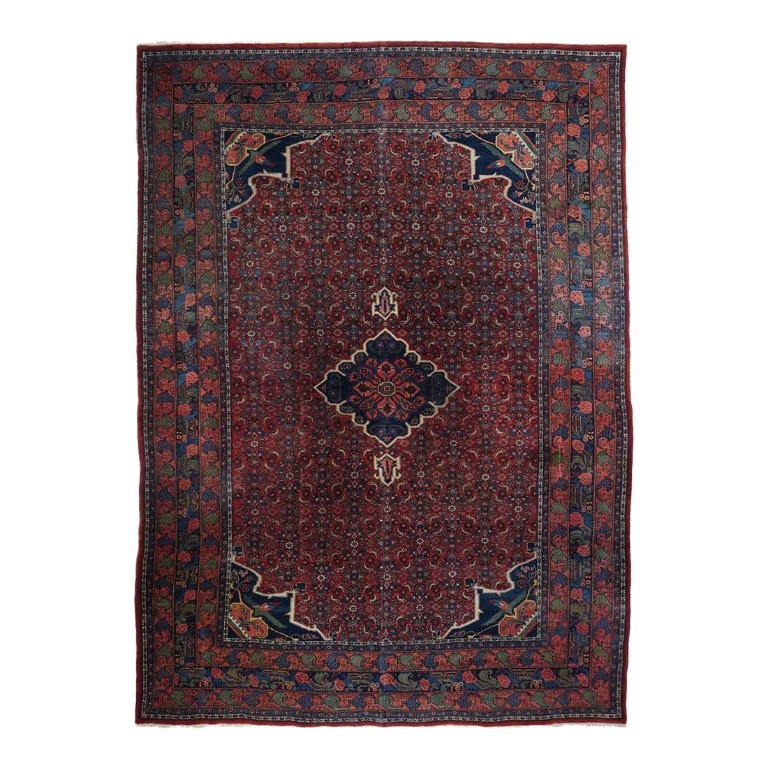 Antique Bidjar Rug 8'10'' x 12'5'': This board-like, compactly woven Kurdish scatter shows a red field covered closely with an allover small Herati design. A cusped and pendanted dark blue medallion floats on top and is matched by the d