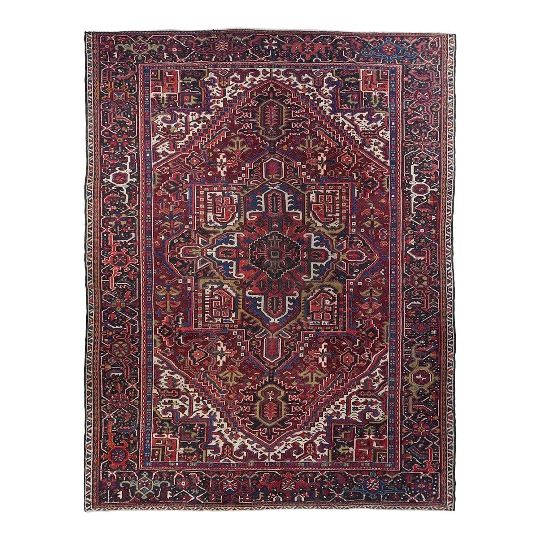Vintage Heriz Rug 7'9'' X 10'8'': A classic vintage Heriz with well-filled conjoint ivory corners, and a rich red field centred by a rather geometric navy-black octogramme medallion presenting a burnt-salmon sub-medallion with ecru
