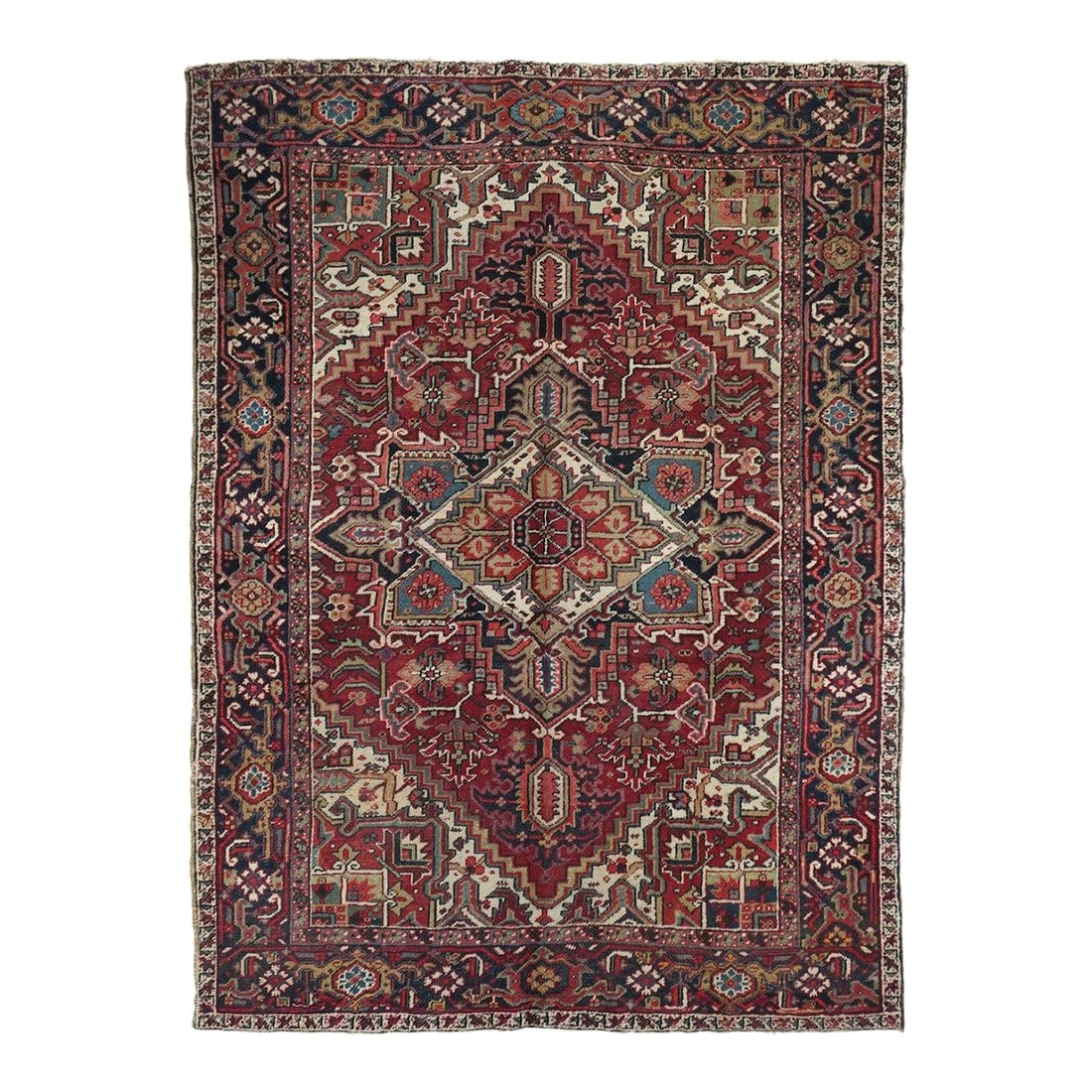 Vintage Heriz Rug 6'7'' X 9'0'': Vintage Heriz Rug 6'7'' x 9'0''. This moderately coarse, but well-woven rustic carpet shows a saturated red field centred by a navy and cream palmette medallion and associated navy pendants. 12 lobe