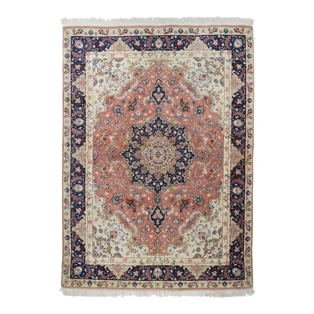 Tabriz Rug 4'9'' X 6'11'': Northwestern Persia This urban carpet clearly shows a Heriz influence, with its semi-geometric drawing of a buff octofoil medallion centred by a light blue concentric sub-medallion. The ragged palette