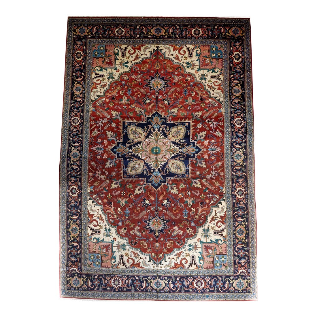 Vintage Heriz Rug 13'2'' X 19'6'': This rather well-drawn rustic carpet shows a scalloped red field cantered by a four palmettes, octogramme navy medallion with ragged palmette pendants. Ivory conjoint corner pieces. Spiky leaves and