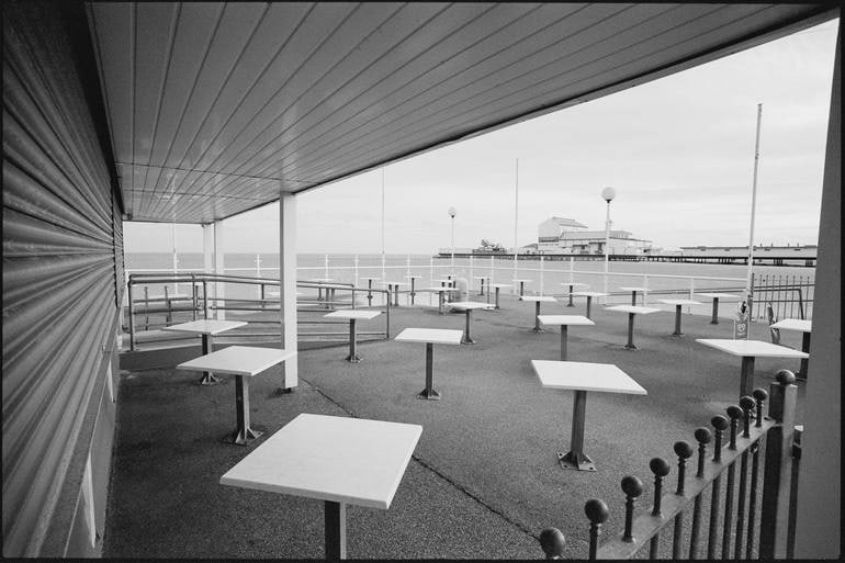 Cafe Tables, Great Yarmouth, Norfolk - Silver Gelatin Photograph: Title: Cafe Tables, Great Yarmouth, Norfolk - Silver Gelatin Photograph Description: 20 x 16 in Medium: Cafe Tables, Great Yarmouth, Norfolk - Silver Gelatin Photograph - Limited Edition of 10 Paul