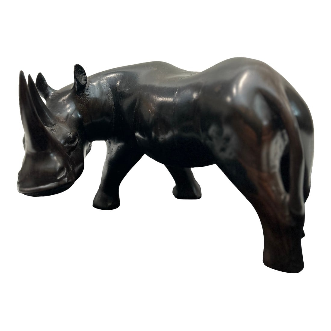 African Blackwood Rhinoceros Figure (Tanzania): This is a finely carved African rhinoceros figure from Tanzania, executed in solid African Blackwood (Mpingo), one of the densest and most prized carving woods in East Africa. Measuring 7 inches in