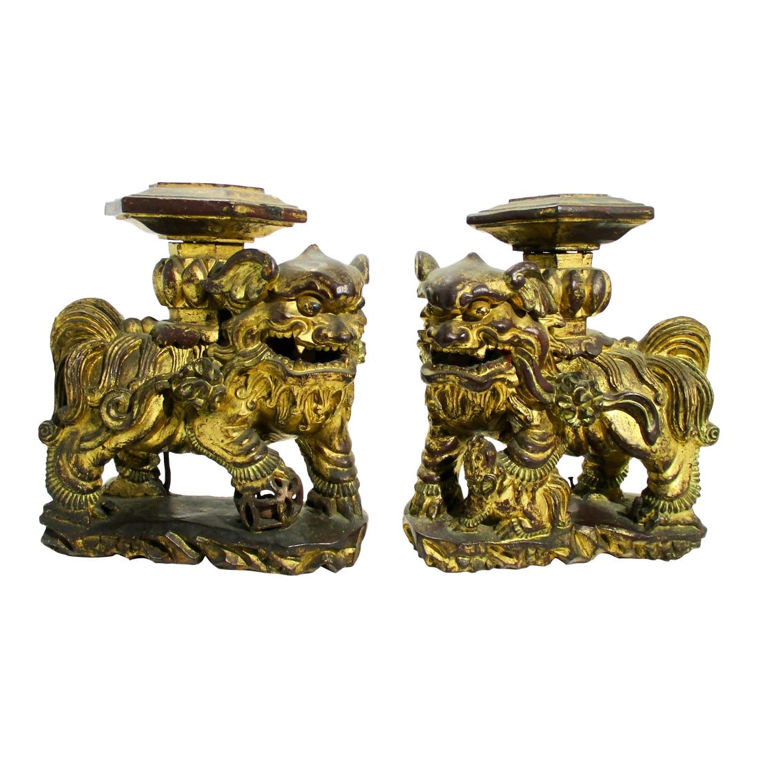 Chinese Gilt Foo Dogs Candle Stands 19th Century - A Pair of 2: Carved male and female foo dogs with gilt surfaces from China, 19th century. The top plateaus have peg holes for attachments or candle holders. Heavy solid wood carving in thick wood to support