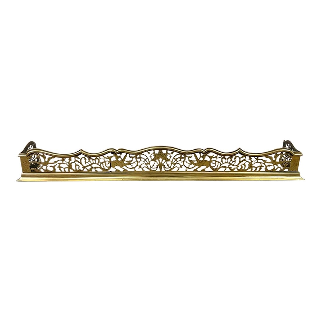 Late 19th Century Late Victorian Brass Fireplace Fender With Pierced Dragon & Foliage Fretwork: A beautifully detailed vintage brass fireplace fender featuring a graceful scalloped crest rail and finely pierced fretwork with dragon and scrolling foliage motifs. The long, low profile gives it an 