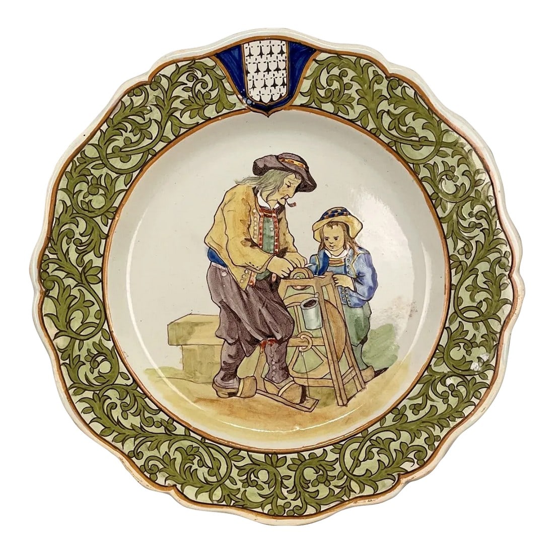 Late 19th Century French Porquier Beau Quimper Plate: A good 19th century French Porquier Beau Quimper Plate with a green border depicting a man with a your child sharpening a knife. good details and in no chips nor hairline. Signed on the back. Minor
