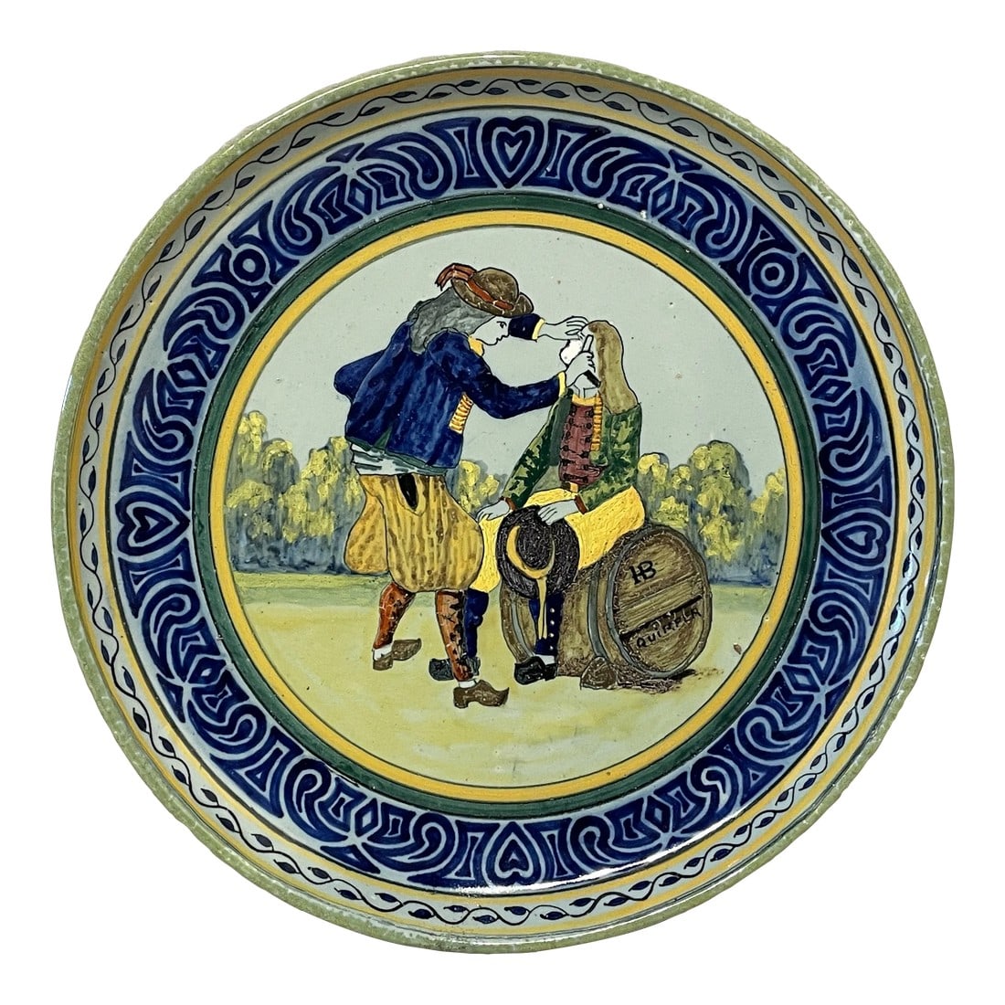 A Early French Hb Quimper Platter: A French large faience platter signed HB Quimper with a blue border, depicting a man shaving another man sitting on a barrel. In great condition with no restorations. Beautiful glazing. Circa 1910.