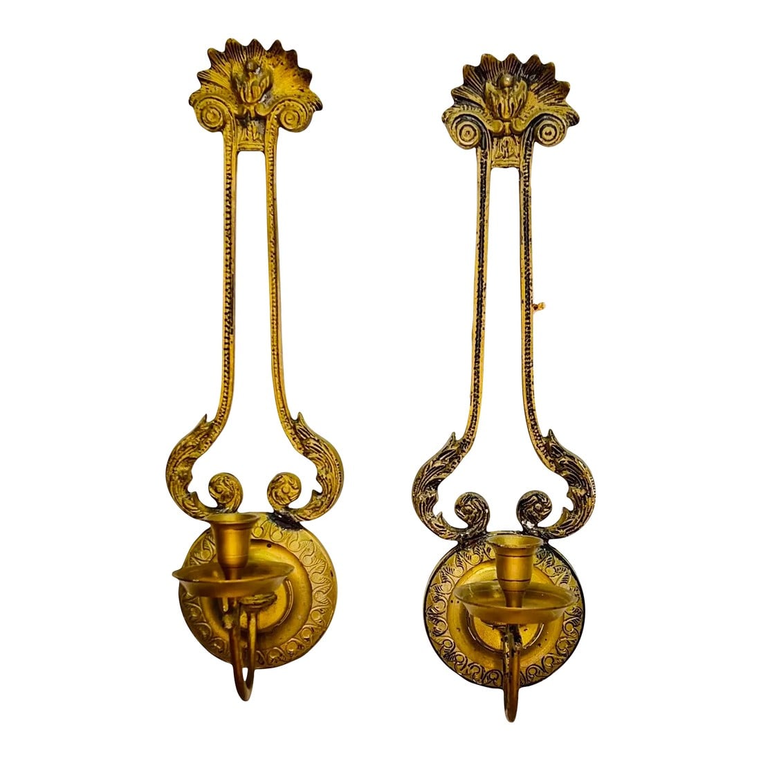 Art Deco Design Candle Sconces - a Pair: Rare brass art deco design candle wall sconces with a half circle of what appear as feathers with a flower in center. Measure 5" w x 6.25" d x 17.5" h. The glaze is much darker on one than the other.