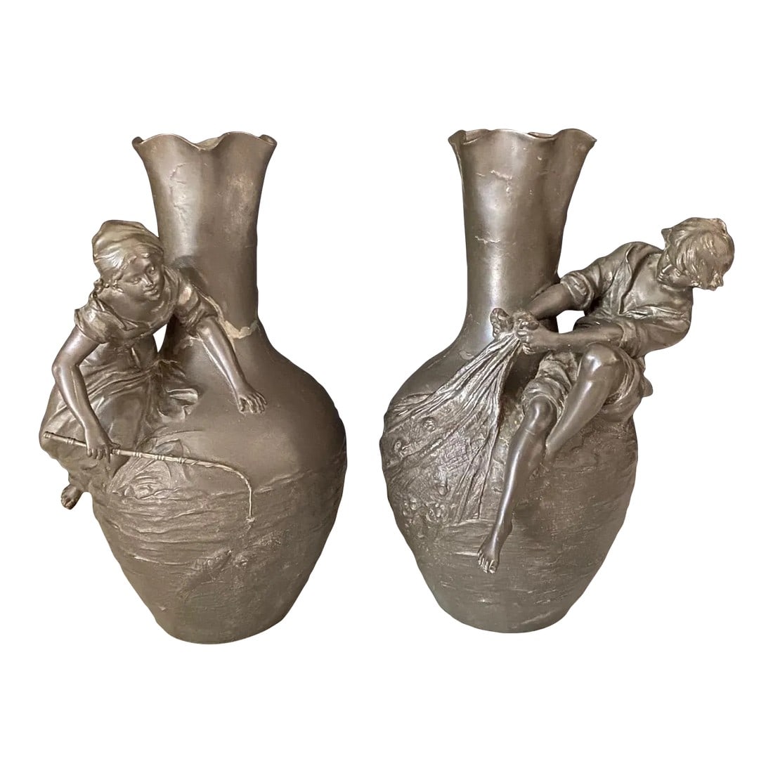 Auguste Moreau Signed French Art Nouveau Sculptural Vases -A Pair: A beautifully sculpted pair of French vases by listed artist Auguste Moreau (1834-1917), each depicting a figure fishing, and each individually signed. The boy figure is casting a net full of fish,