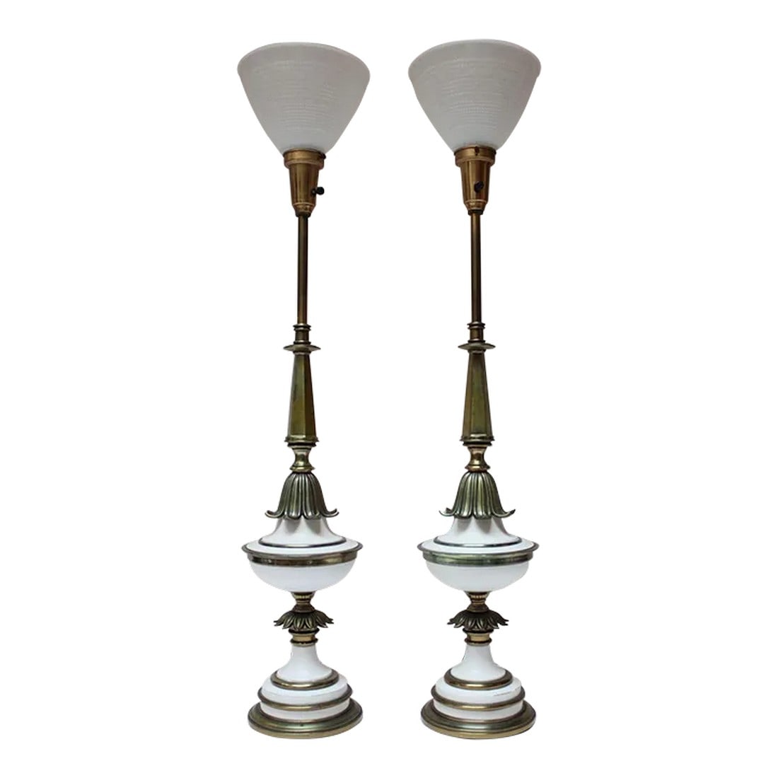Pair of Hollywood Regency-Style Brass and Glass Stiffel Table Lamps: Statuesque Hollywood Regency-Style table lamps by Stiffel composed of solid brass stems and adornments with white enameled metal accents. Includes glass shades/diffusers only (the brown linen shades