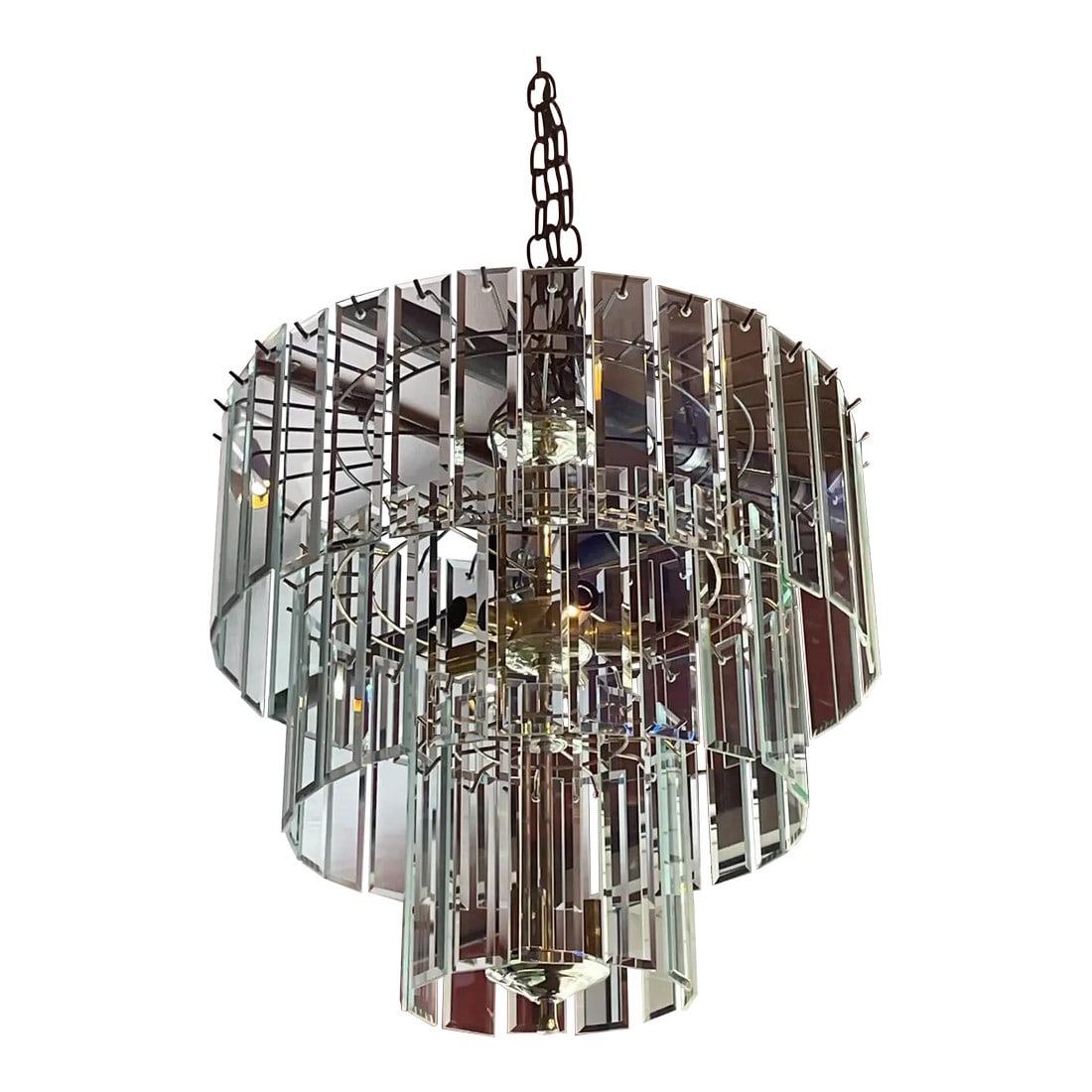 Mid Century Modern Three Tiered Glass Chandelier: This three tiered and elegant mid century modern glass chandelier is ready to light up any room in your house. The three tiers add an elegance and the strategically placed glass elements allow for