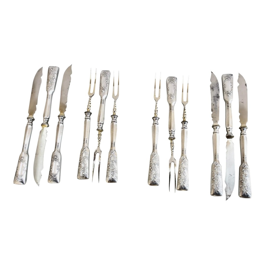 Silver Cocktail Knives and Forks -Set of 12: Arts and Crafts cocktail sets of 6 forks and 6 knives. Nicely weighted handles and designed with a branch work of angular flowers and foliage. The blades are notched and the handles are weighted. The 