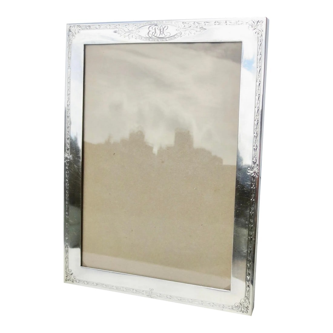 Gorham Sterling Silver Photo Frame Circa 1919: Sterling silver photo frame with velvet back cover. Edwardian period with modern square form framing. floral-designed border graphic and a medallion with a monogram at the top. Bottom corner closures