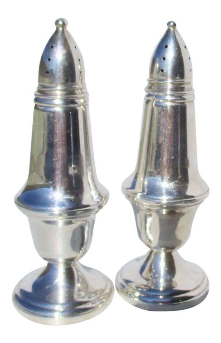 Crown Silver Salt and Pepper Set - a Pair: Silver Salt and Pepper set from Crown. Weight and footed design with glass liners set into the silver bodies. Companion designs with matching bodies and sized shaker holes. Size 1.8" diameter of the f