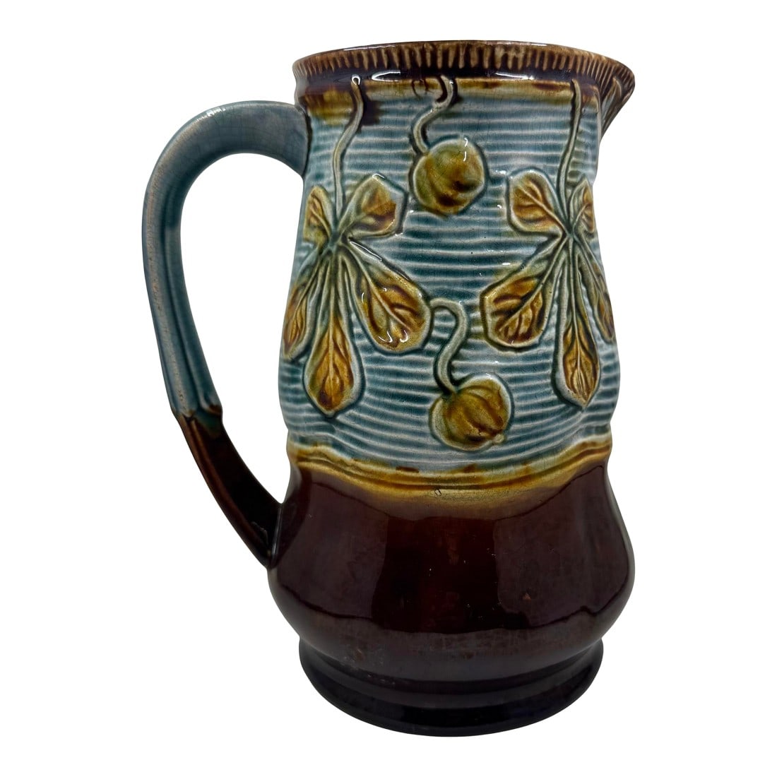 Vintage 1930's French Majolica Pitcher /Jug With Golden Leaf Design: Stately Vintage 1930's French Majolica Pitcher/Jug decorated with a golden leaf design. Pitcher is a classic brown with striped aqua panel containing a golden leaf pattern. Condition: Alterations: