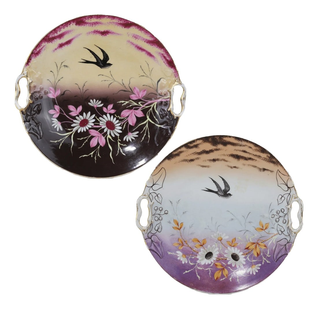 Pair of Vintage Hand-Painted Porcelain Decorative Plates With Bird and Floral Motifs: This stunning pair of vintage porcelain plates showcases hand-painted swallows in flight, surrounded by beautifully detailed floral landscapes. The soft gradient backgrounds and intricate gold