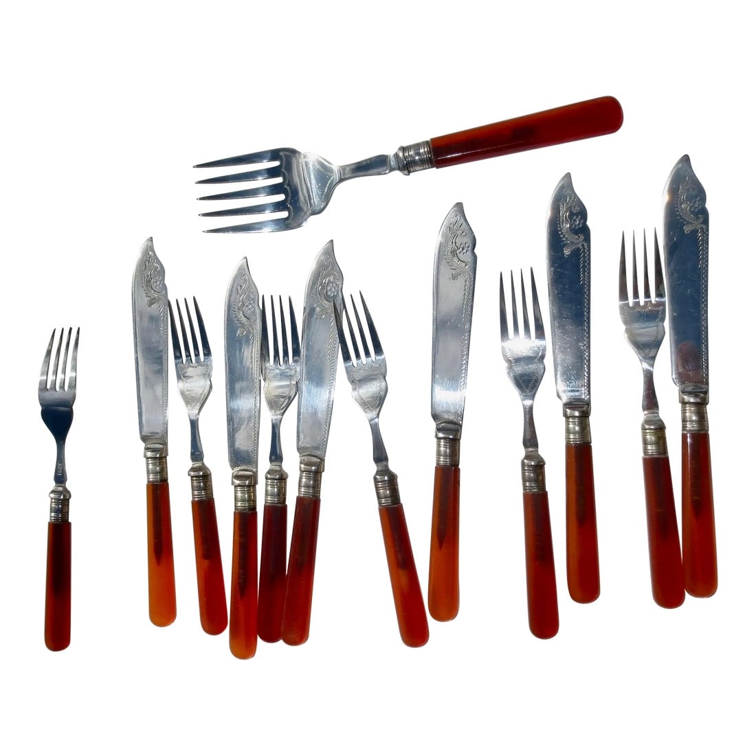 Bakalite Fish Set With Server: Six pairs of forks and knives with a large fork server. Carnelian color bakalite with the hallmark of EPNS. made in England circa 30s-40s', Beaux arts engraved details on the blade and on the forks.