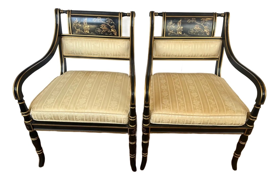 Black & Gold Hollywood Regency Armchairs by Baker -a Pair: Elegant pair of Chinoiserie decorated armchairs having black backgrounds with gold and red figural design. Seat is upholstered and should be redone. Condition: Alterations: Original Condition