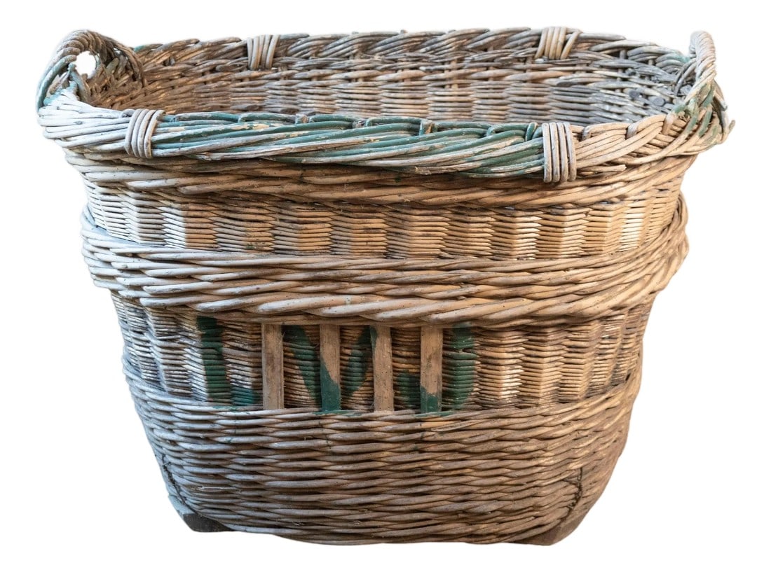 Early 20th Century French Wicker Grape Harvesting Basket: An authentic French grape harvesting basket from the 1940s, sourced from the vineyards of Champagne. Handwoven from sturdy willow, this generously sized basket features a distinctive twisted rim and r