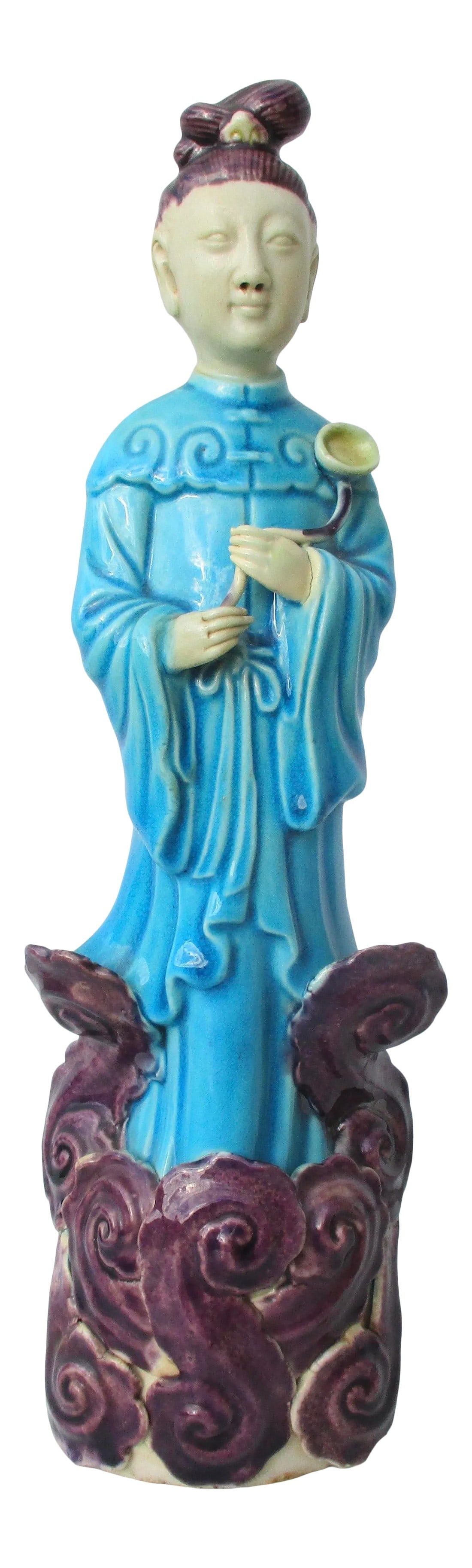 Chinese Aubergine Turquoise Immortal on Clouds Porcelain: Chinese fine porcelain figure of an Immortal on a cloud work base. Glazed in Aubergine and turquoise, the figure of a standing immortal holding a lotus leaf against his chest. Finely formed and