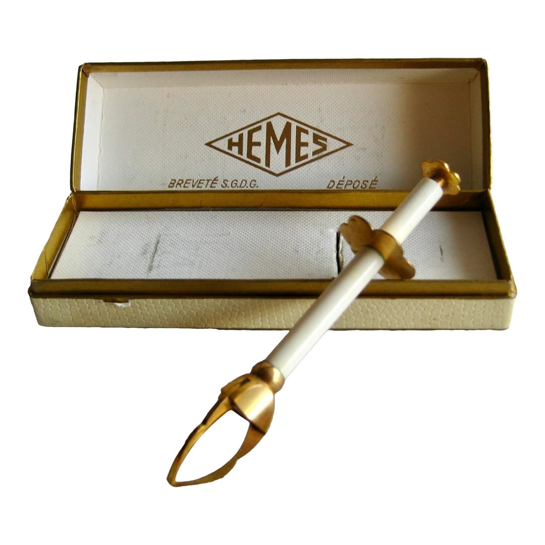 1960s Mid Century Modern Ice or Sugar Tong: This is a lovely piece strong in style with it s pure line and color combination between the white and the gold , it is in the original box , and we notice a stamp on the top that probably stand for