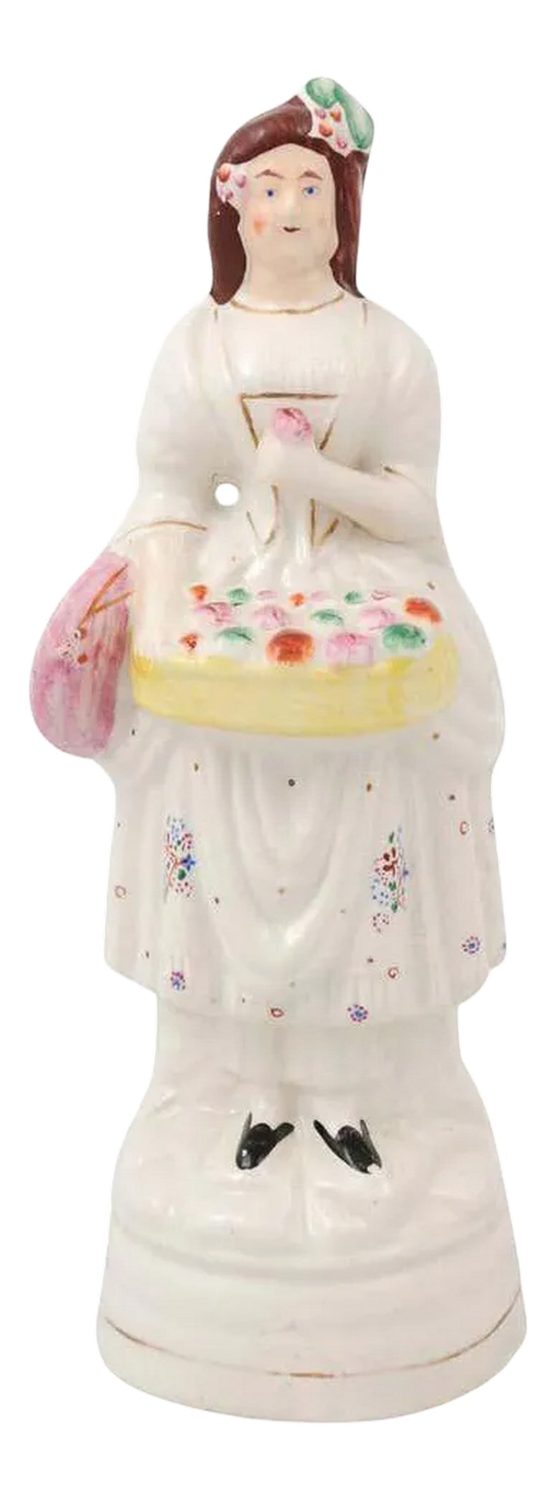 Early 20th Century English Porcelain Decorative Object Depicting Lady With a Floral Basket: A small English porcelain decorative object depicting a lady carrying a floral basket. Created in England during the 20th century, this petite sculpture depicts a young lady, dressed in white with