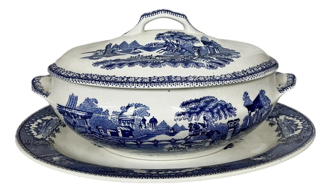Vintage Blue and White Transferware Tureen and Underplate Marked Gilman & Co Sacavem, Portugal: Vintage blue and white transferware soup tureen with under plate. Marked Gilman & Co Sacavem, Portugal. Under plate measures 14.5" w x 11.5" d x 1.25" h, tureen measures 12.5" w x 8.25" d x 7" h. No